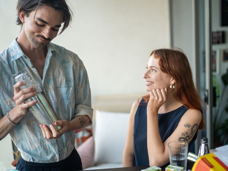 couple making cocktails at home